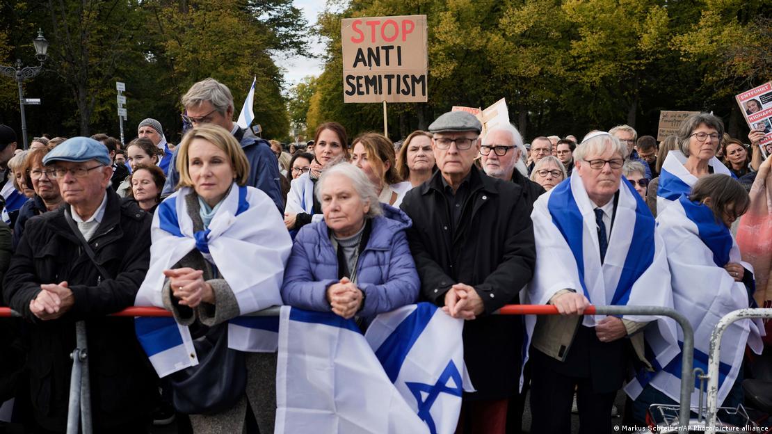 People wearing Israeli flags rally to show solidarity with Israel in Berlin