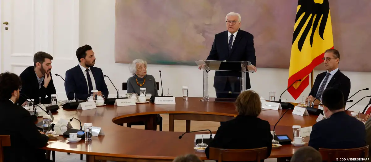 German President Frank-Walter Steinmeier stands next to a German flag and addresses representatives of Jewish and Muslim organisations