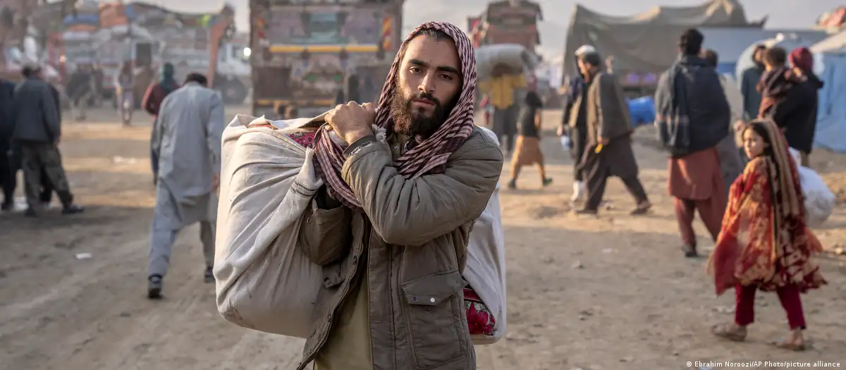 An Afghan refugee carrying a load in Pakistan