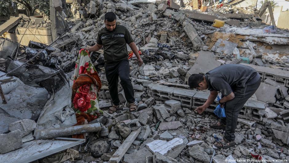 Palestinians inspect a house that was destroyed after an Israeli aircraft bombed a home for the Al-Bakhabsa family, resulting in the death of 3 people and several wounded, in the city of Rafah, southern Gaza