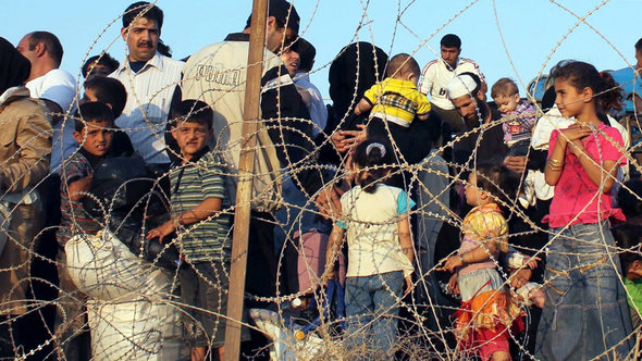 Syrische Flüchtlinge an der Grenze zur Türkei; Foto: picture-aliance/dpa
