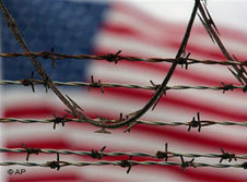 US flag behind barbed wire (photo: AP)