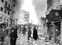 Civilians walk through the debris-laden Ben Yehuda street in Jerusalem following the explosion in the heart of the city's Jewish business district on Feb. 22, 1948 (photo: AP)