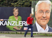 Frank-Walter Steinmeier and Angela Merkel on election posters (photo: AP)