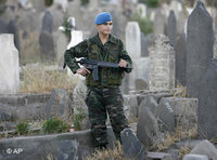 Turkish soldier on guard omn a graveyard (photo: AP)