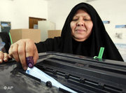 Iraqi woman casting her vote (photo: AP)