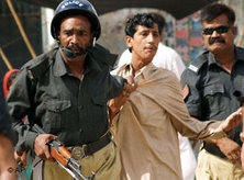 Pakistani police officers arrest a protester in Karachi, Pakistan, 14 May, 2007 (photo: AP)