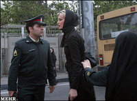 Iranian police officers interrogate a woman on her clothing (photo: MEHR)