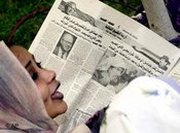 Arab woman reads newspaper, photo: AP