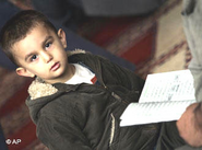 Muslim boy holding a Koran (photo: AP)