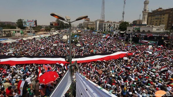 Egyptian supporters of the Muslim Brotherhood and deposed president Mohamed Morsi deploy a giant national flag during a rally outside Cairo's Rabaa al-Adawiya mosque on July 12, 2013, following Friday noon prayer (photo: AFP/Getty Images)