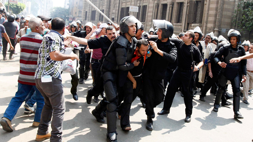 Police detain a supporter of ousted Egyptian President Mohamed Mursi during clashes in central Cairo August 13, 2013 (photo: Mohamed Abd El Ghany / Reuters)
