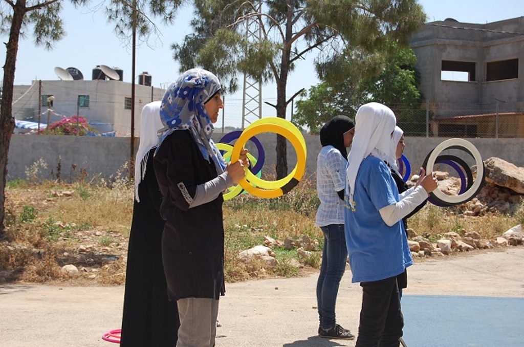 A group of girls learning to juggle with hoops (photo: Palestinian Circus School)