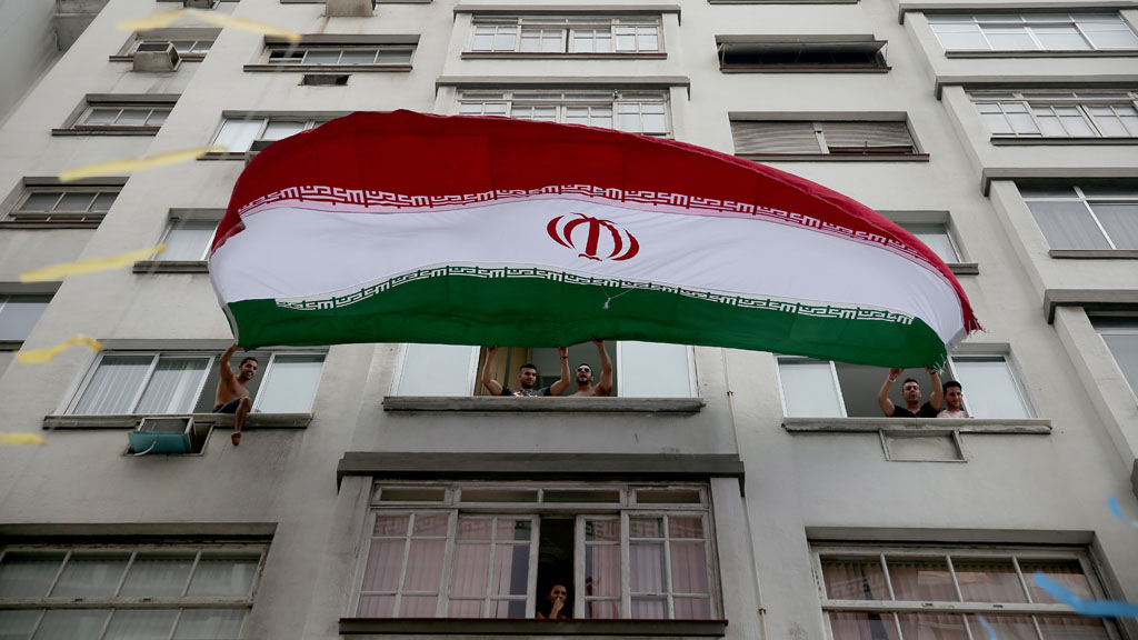 Iranian soccer fans wave a huge Iranian flag from their windows as the World Cup tournament enters its second day on 13 June 2014 in Rio de Janeiro, Brazil (photo: Joe Raedle/Getty Images)