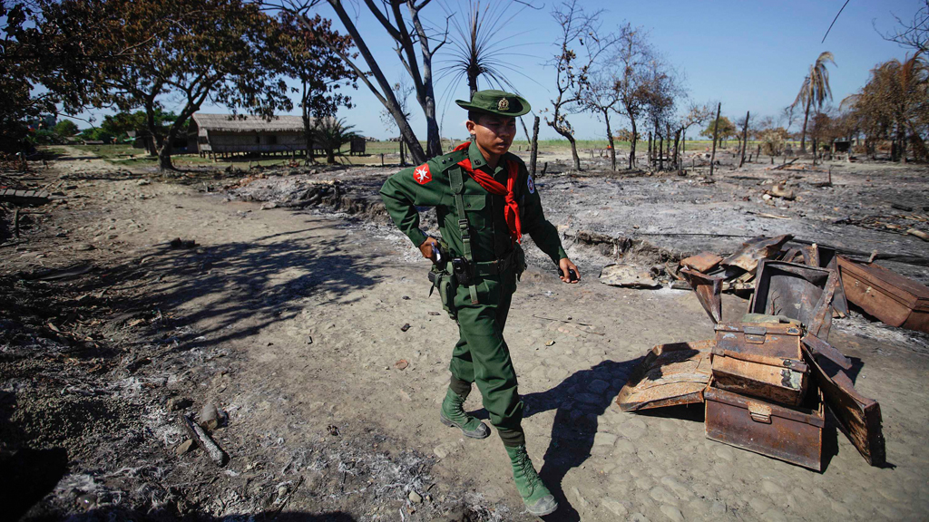 A soldier walks amid the rubble of a neighbourhood in Pauktaw township, Myanmar, which was burned in violence in October 2012 (Reuters)