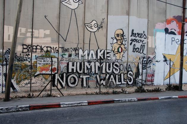 Graffiti that reads "Make hummus not walls" (photo: Laura Overmeyer)