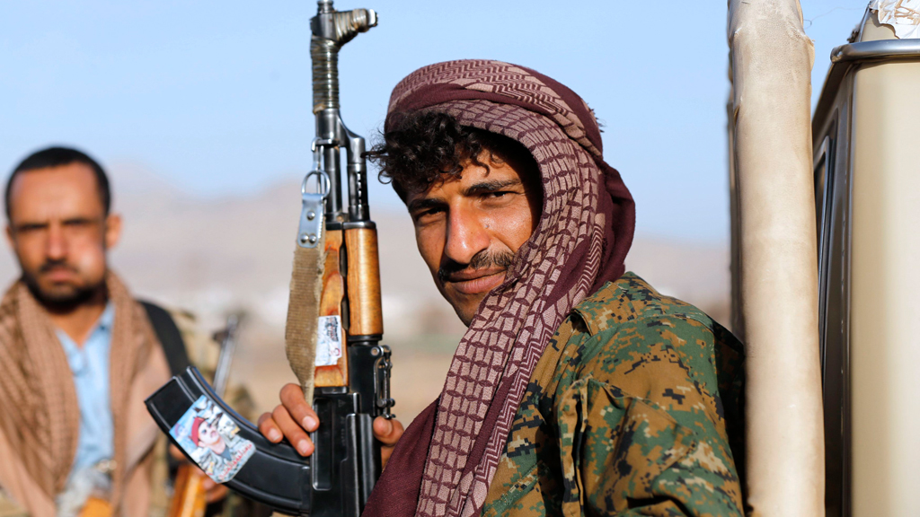 A Houthi fighter holds a rifle with a sticker portraying Ahmed Ali Abdullah Saleh, the eldest son of Yemen's former president Ali Abdullah Saleh, Sanaa, 22 January 2015 (photo: Reuters/Abdullah) 