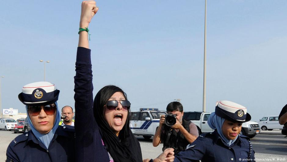 Bahraini rights activist Zainab Al-Khawaja being arrested by two police women while on a march