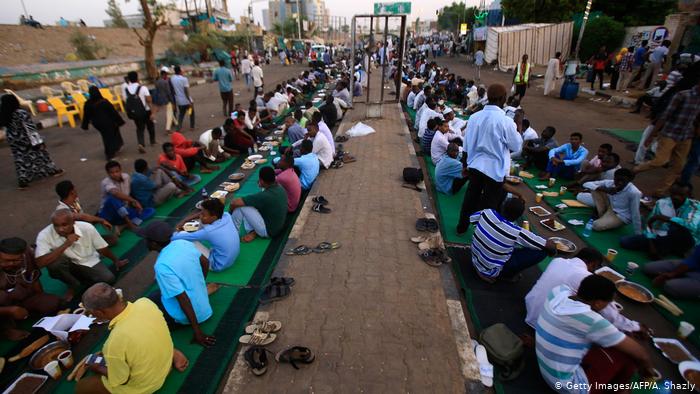 Protesters sit in rows on the ground while breaking fast (photo: Getty Images/AFP/A. Shazly)