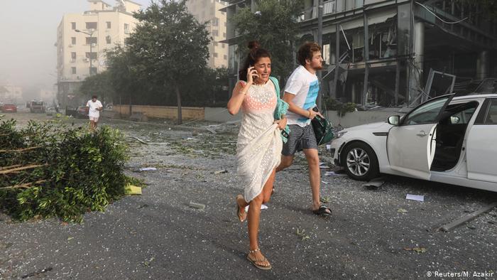 Man and woman running in Beirut (photo: Reuters/M. Azakir)