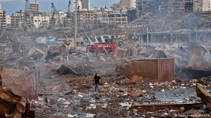 Aftermath of Beirut blasts, man walks through rubble (photo: Getty Images/AFP/STR)
