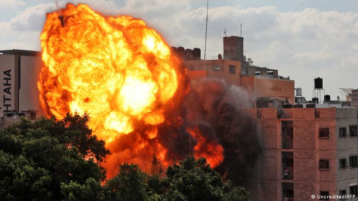 A ball of fire engulfs the Al-Walid building, which was destroyed by an Israeli airstrike on Gaza city early in the morning