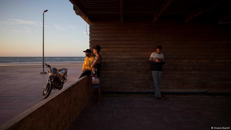 Ahmaida Manssour, 31, a surf coach, and his friends spend time together at Nuevas Olas surf club, before iftar (photo: Imane Djamil)