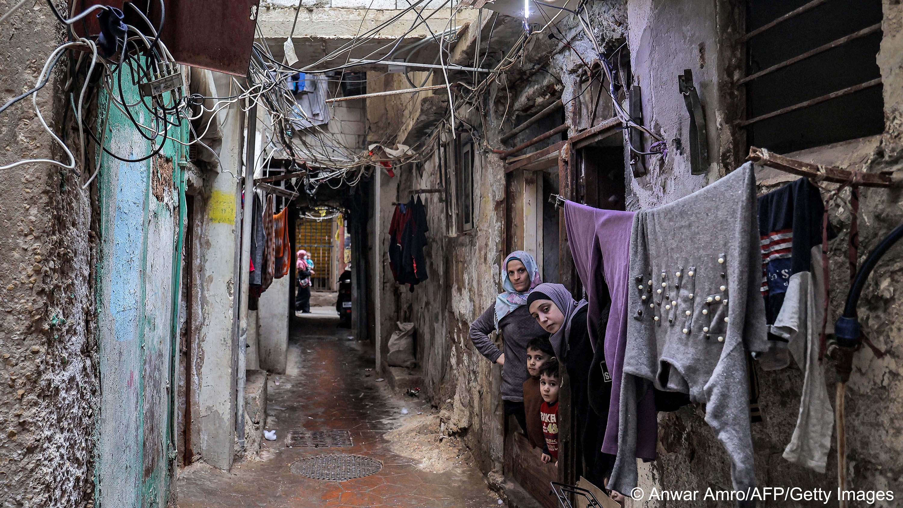 Women and children look out of a doorway in the Shatila camp for Palestinian refugees in the southern suburbs of Beirut, 19 April 2023 (photo: Anwar Amro/AFP/Getty Images)