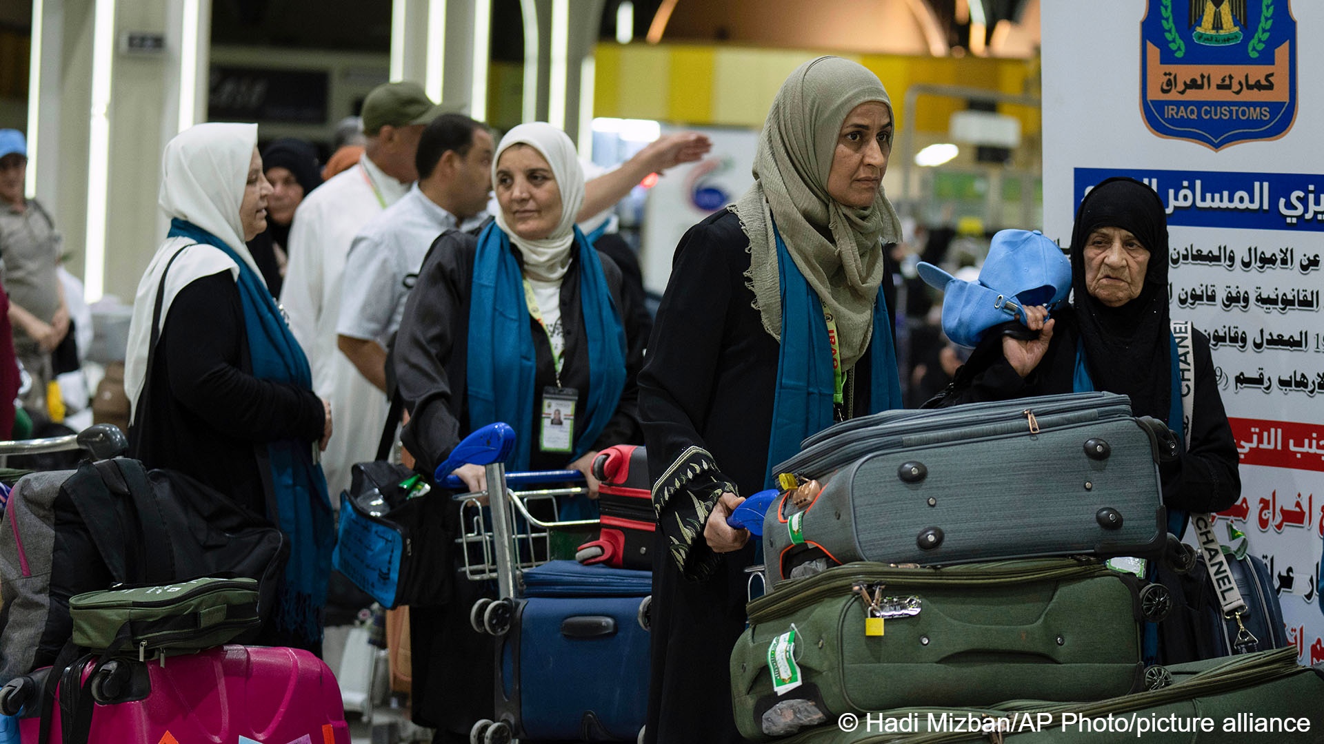 Iraqi pilgrims are heading to Mecca for Haj, the holiest place in Islam, at the Baghdad Airport in Baghdad, Iraq, 7 June  2023 (image: AP Photo/ Hadi Mizban)