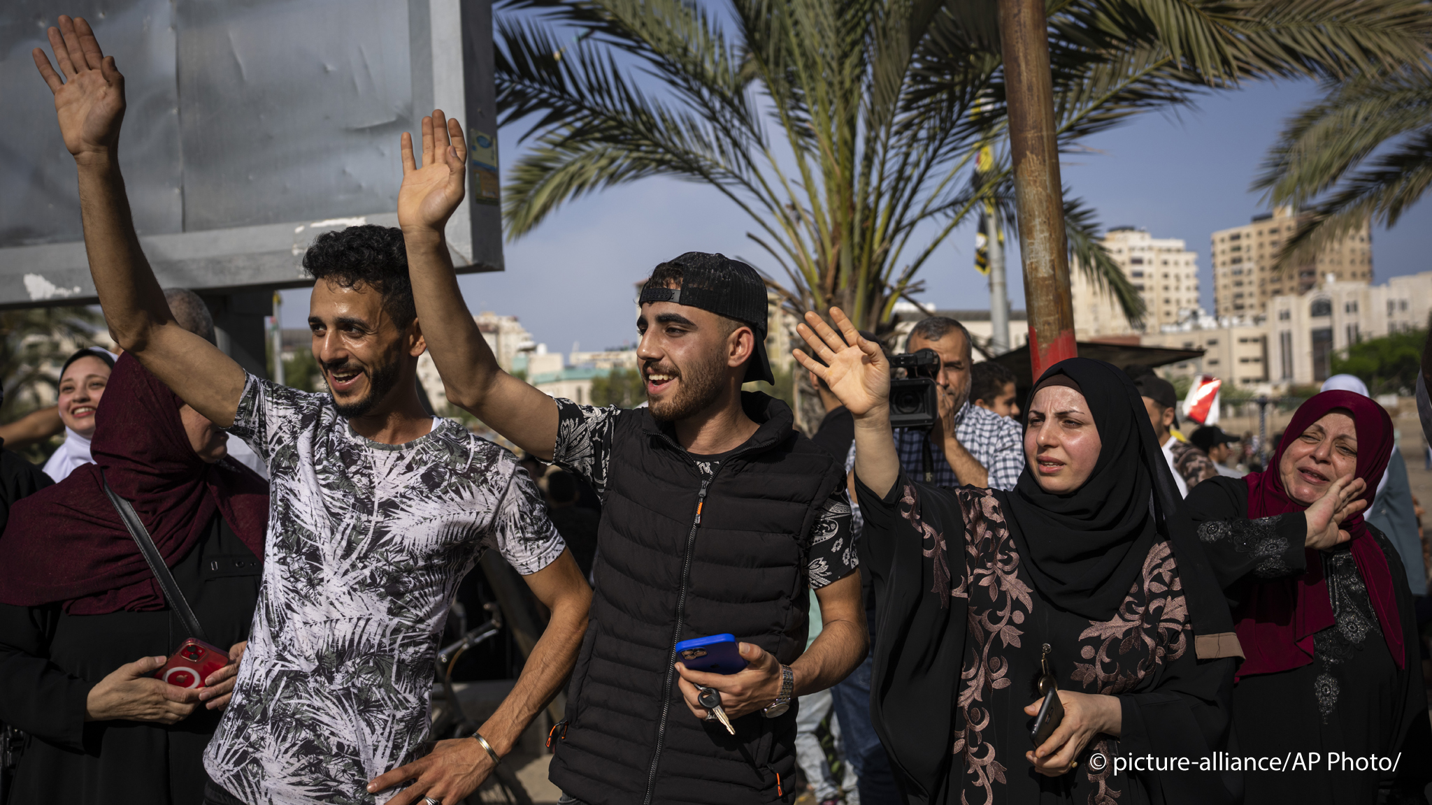 Relatives of Huda Zaqqout wave to say goodbye as she leaves Gaza City for the Hajj pilgrimage in the holy city of Mecca, 13 June 2023 (image: AP Photo/Fatima Shbair)