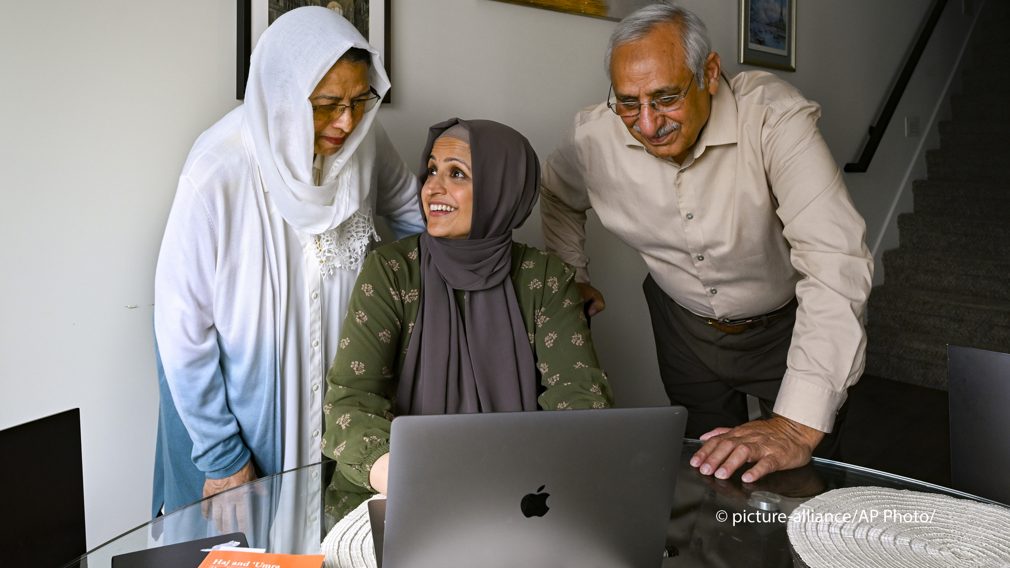 Muslim family members Saadiha, seated, Saeeda, and Abdul Khaliq, right, gather around a computer which they use to research for their hajj trip, pictured Wednesday, June. 7, 2023, in Murfreesboro, Tenn. The Khaliq family are planning to travel together to Mecca in Saudi Arabia for hajj, pilgrimage which every adult Muslim who can afford it and is physically able must make at least once in his or her lifetime. The hajj is the fifth of the fundamental Muslim practices and institutions known as the Five Pillar