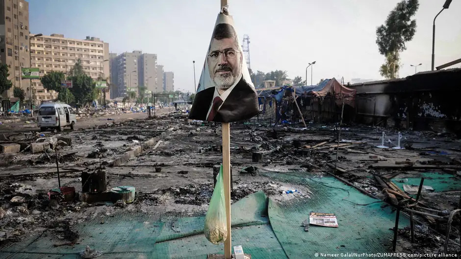 A poster of Egypt's ousted president, Mohammed Morsi, in the debris of the Rabaa protesters' camp (image: Nameer Galal/NurPhoto/ZUMAPRESS.com/picture alliance)