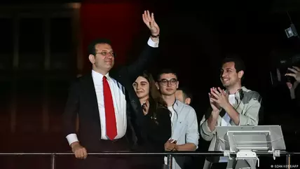 Istanbul Mayor Ekrem Imamoğlu waves in front of supporters as they celebrate outside the main municipality building following municipal elections across Turkey, Istanbul, 31 March 2024