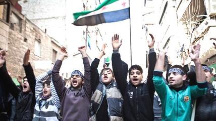 Young men and youths demonstrating against the Assad regime in the area of al Qaterji, north-east of Aleppo, waving the flag of the Free Syrian Army (photo: dpa)