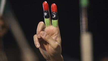Man shows the victory sign during an anti-Gaddafi demonstration in August 2011 (photo: AP)