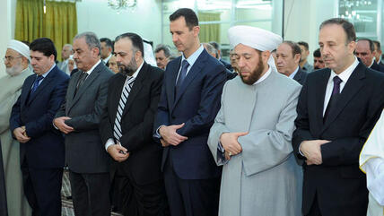 Syria's President Bashar al-Assad (centre) attends Eid Al Fitr prayers at al-Hamad mosque in Damascus (photo: Reuters)