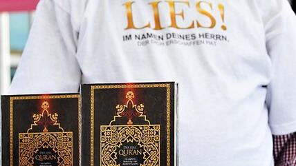 A Salafist distributing free copies of the Koran on Potsdamer Platz in Berlin. The inscription on the T-shirt reads 'READ! In the name of the Lord who created you' (photo: dapd)