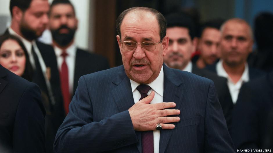 Former Iraqi Prime Minister Nouri al-Maliki gestures as he arrives to vote during Iraq's provincial council elections