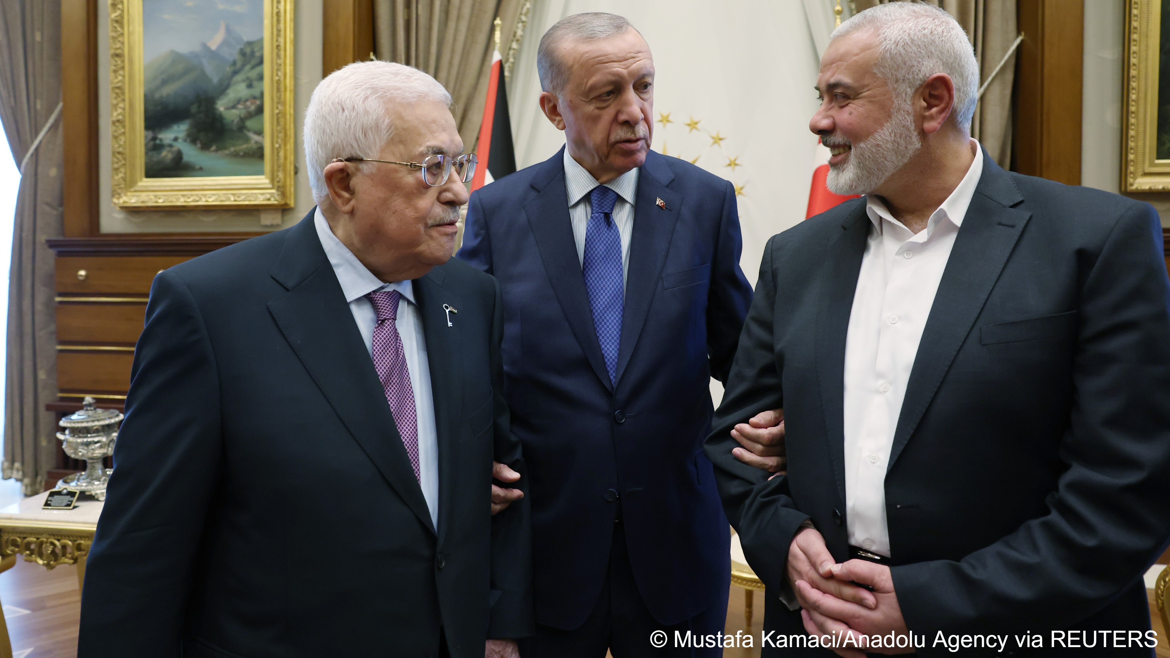 Turkish President Recep Tayyip Erdogan (centre) holds the arms of Palestinian President Mahmoud Abbas (left) and head of the Hamas Political Bureau Ismail Haniyeh (right) at the Presidential Complex in Ankara, Turkey, 26 July 2023