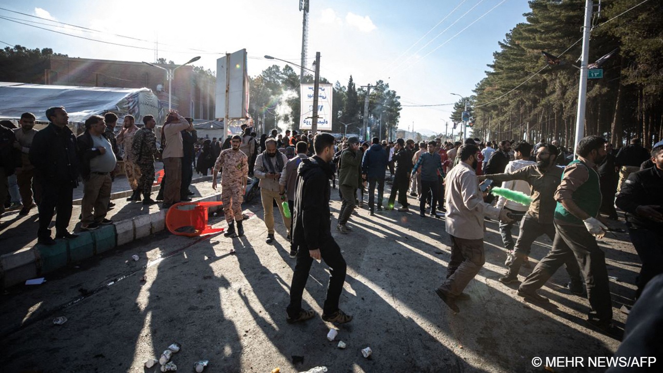 People disperse near the site where two explosions in quick succession struck a crowd marking the anniversary of the 2020 killing of Guards general Qassem Soleimani, near the Saheb al-Zaman Mosque in the southern Iranian city of Kerman, 3 January 2024