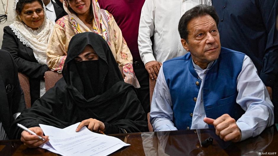 Pakistan's former Prime Minister, Imran Khan (R) along with his wife Bushra Bibi (L) looks on as he signs surety bonds for bail in various cases, at a registrar office at the High Court in Lahore, Pakistan, July 2023