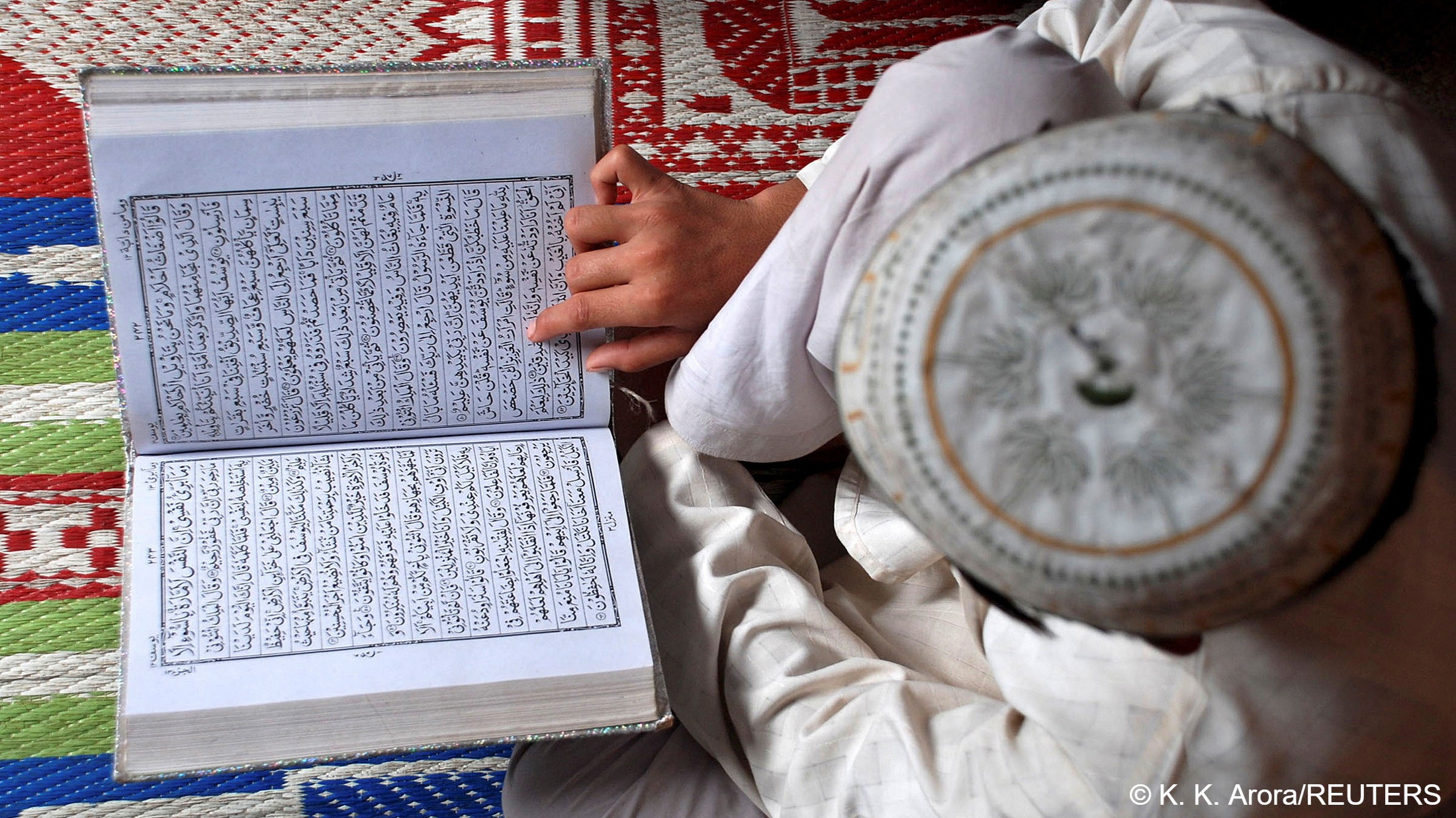 A Muslim boy reads the Koran at a madrassa or religious school on the first day of the holy month of Ramadan in the northern Indian city of Mathura