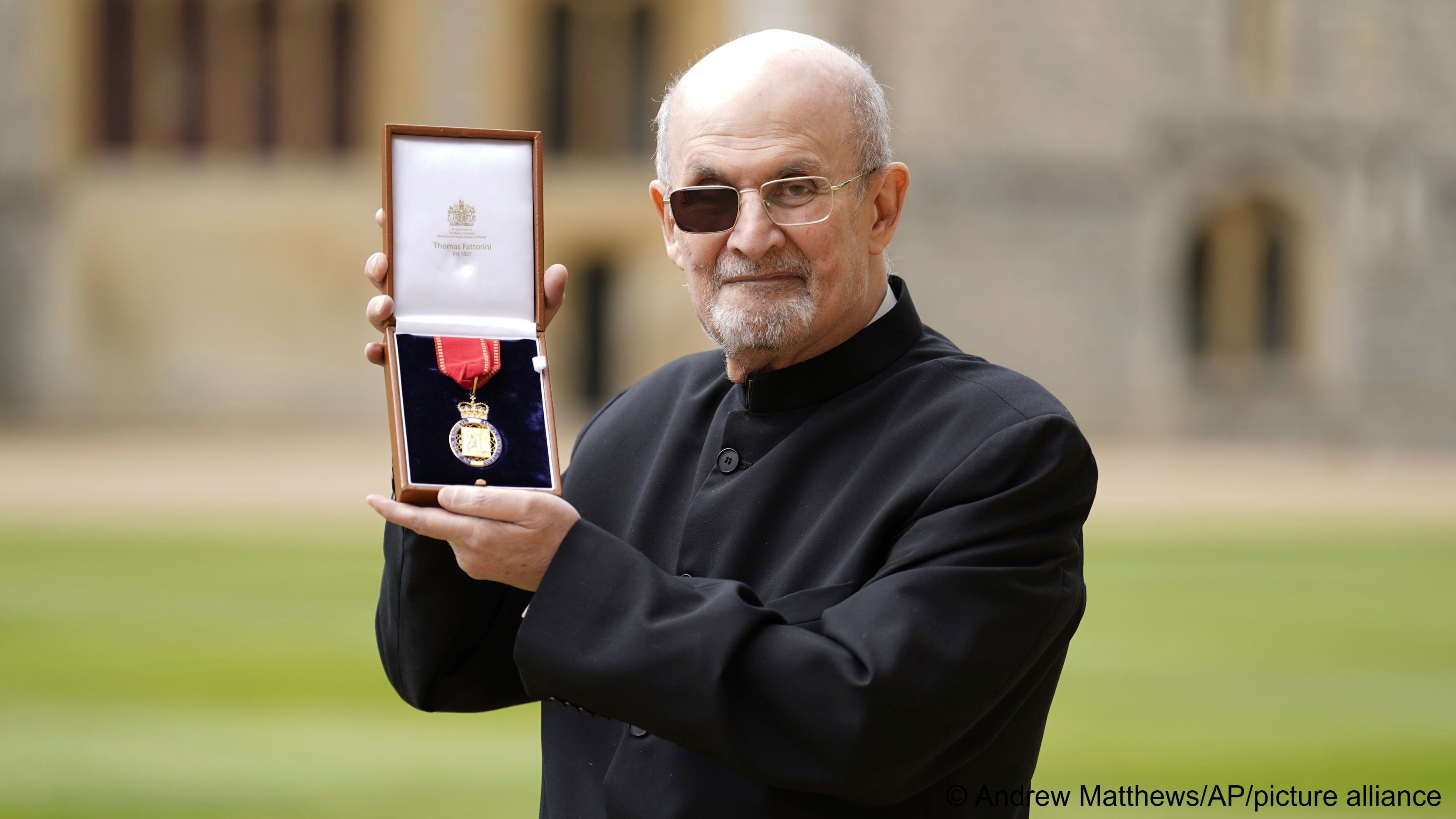 Sir Salman Rushdie poses after being made a Companion of Honour by Britain's Princess Anne during an investiture ceremony at Windsor Castle, England, 23 May 2023 