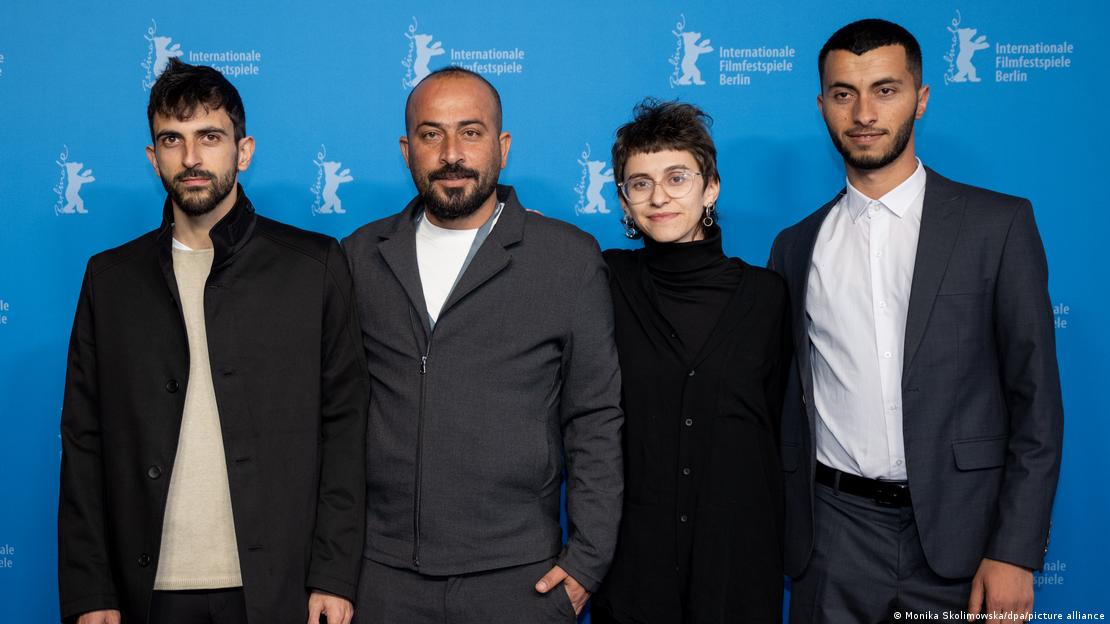 The directors of "No Other Land" (from left to right): Yuval Abraham, Hamdan Ballal, Rachel Szor and Basel Adra stand in front of a wall bearing the Berlinale inscription