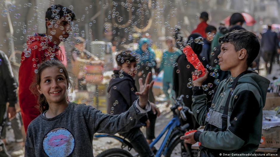 Children in Deir al-Balah in the Gaza Strip play carefree with soap bubbles