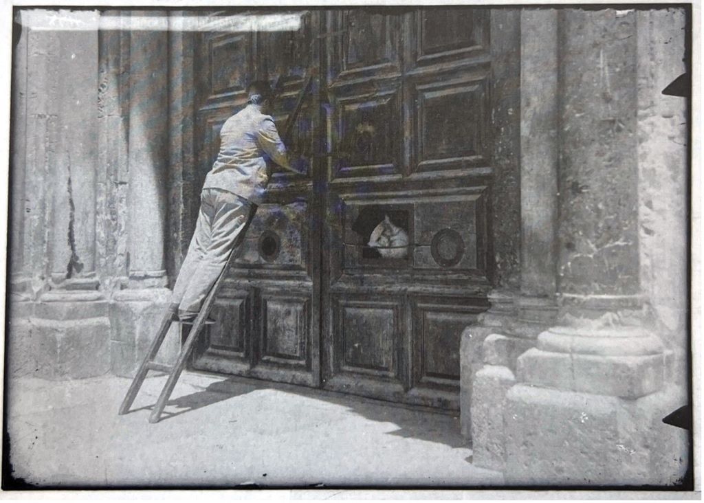 A member of the Nuseiba family unlocking the Church of the Holy Sepulchre in Jerusalem
