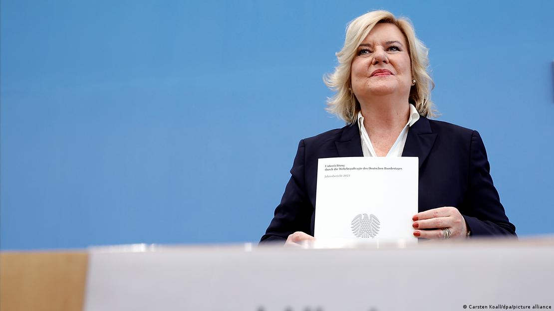 Parliamentary commissioner for the German armed forces Eva Högl smiles as she holds up her third annual report in her role as commissioner 