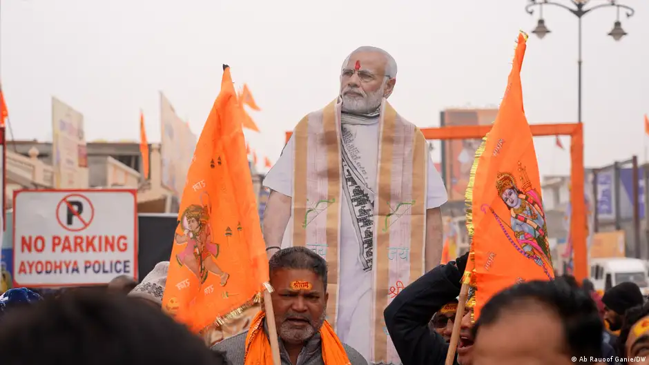 Men hold flags and an effigy of Indian Prime Minister Narendra Modi at the ceremony marking the consecration of the Ram temple in Ayodhya, India