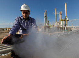A Libyan oil worker works at a refinery inside the oil complex in Brega, east of Libya, on Saturday 26 February 2011 (photo: AP)