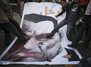 Jubilant demonstrators stamp on a poster depicting Mubarak in Cairo (photo: AP)